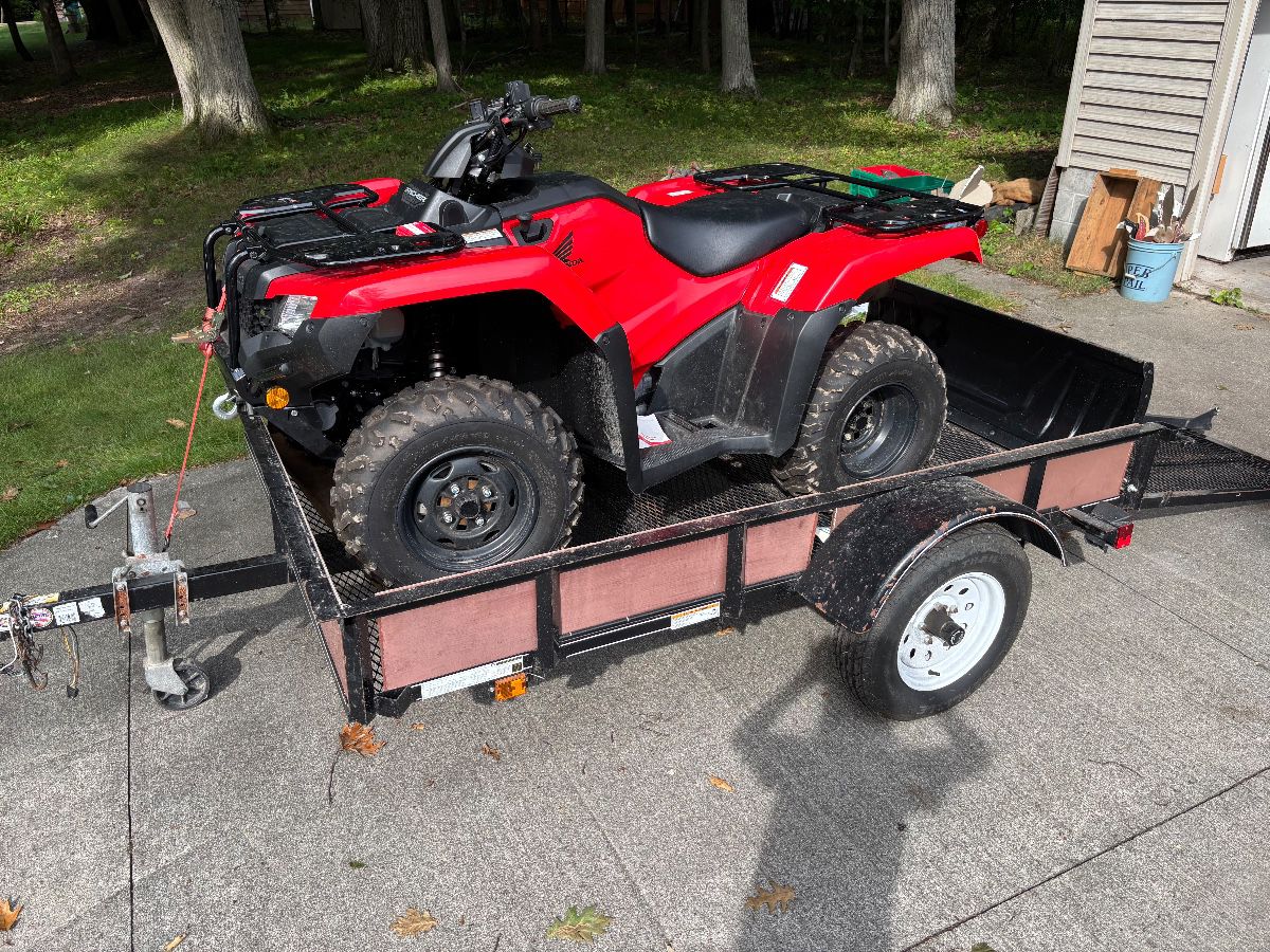 Honda Rancher 4x4 -  year 2023 with 24 miles on it  Also includes Trailer