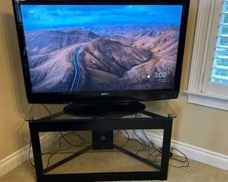 Sanyo 48 TV With ROKU On A Contemporary Black Metal Glass Corner Tv Stand