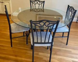 Round Glass Top Dinning Table Set With Four Matching Chairs And Scrolling Metal Backrest
