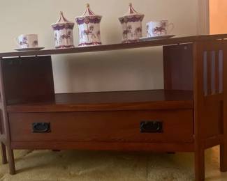 Attractive grouping featuring a carouselthemed porcelain collection displayed with a sapele wood co