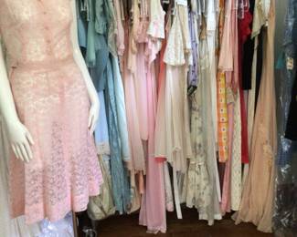I call this the Pretty Dress Rack. Shown is a 1940s 2 pc pink set with all over surface embroidery. Studio room