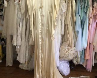 late 1930s - early 1940s candlelight silk satin wedding gown with adornments. Studio room.