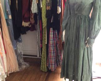 This rack has early to 1950s very special pieces. Civil War green striped dress. Studio room.