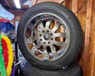 Set of 4 Toyo Open Country light truck tire with size LT325/50R22 mounted on a chrome wheel rims.