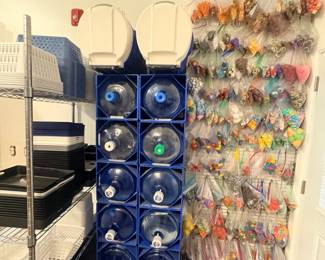 TS004 Water storage area with stacked 5gallon bottles in blue racks and two large insulated beverage coolers