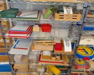 LE015 Wire shelving with wooden Montessori lesson boxes trays and mixed materials