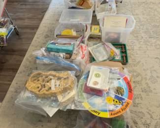 LE033 Floor grouping of bagged lesson materials bins and manipulatives weather wheel visible