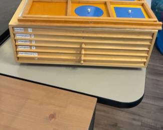 LE050 Montessori Geometry Cabinet closedpartial view labeled drawers for circles rectangles triangles polygons and c