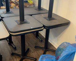 LE055 Additional black pedestal classroom tables shown upside downstacked