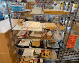 LE026 Wire shelf of trays baskets lesson folders and assorted Montessori teaching materials