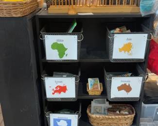 LE001 Geography storage cabinet with continentlabeled baskets flag display visible above