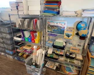 LE031 Wire shelving with curriculum binders globes framed materials trays and lesson resources