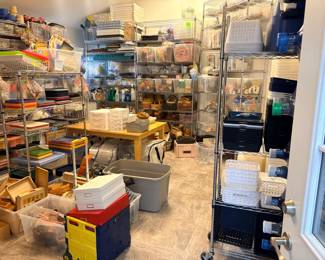 TS003 Teacher Storage room overview with dense wire shelving bins baskets trays and center wood table