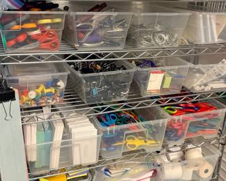 TS021 Close view of officesupply shelving with scissors binder clips rings paper toilet paper and bins