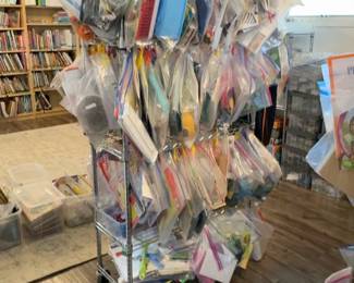 LE029 Alternate side view of rolling rack with many bagged Montessori lesson sets