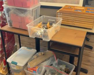 LE048 Tablefloor grouping of clear bins containing Montessori manipulatives and teaching materials
