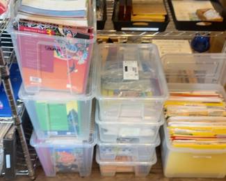 LE022 Stacked clear storage bins containing books lesson folders and classroom materials