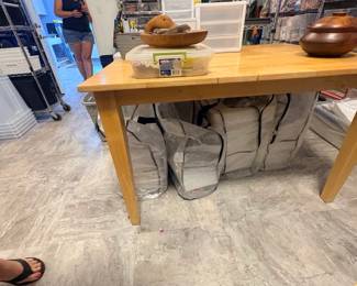 TS028 Wood worktable with four large silver zippered picnic in a bag kits beneath each serves about 200 children