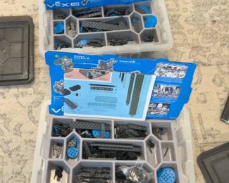 LE043 Two open VEX IQ robotics kits with parts trays and instruction materials