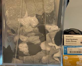 TS001 Clear storage bin of brandnew socks boxed vinyl exam gloves beside it