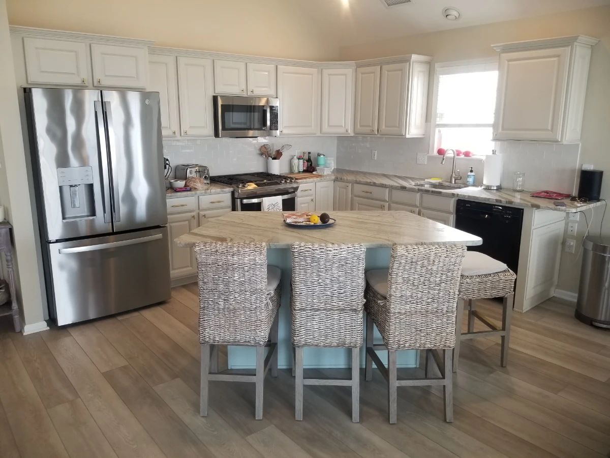 Stylish kitchen with plenty of base & upper cabinets. GE refrigerator model GFE26JMNFFS