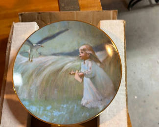 Lot 19: Two round decorative plates featuring a girl in a white dress