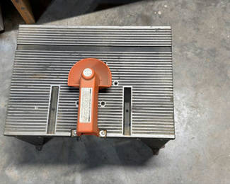 Lot 38: Metal worktable with orange clamp attachment