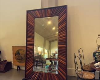 This mirror is amazing.   The story is  that a piano maker that made custom pianos saved a piece of wood from each piano he made and then made the mirror out of it.  