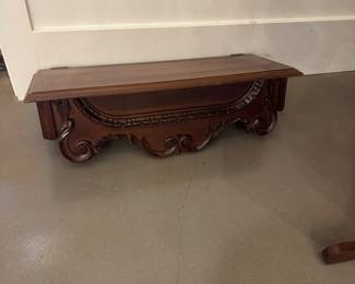 Ornate wall mounted shelf.  Opens at top