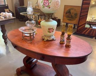 Double Globe Hurricane Lamp and Antique Oval Library Table