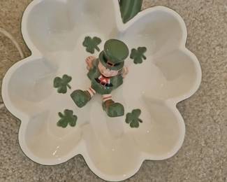 A ceramic four-leaf clover candy dish with a central leprechaun figurine by Russ Berrie