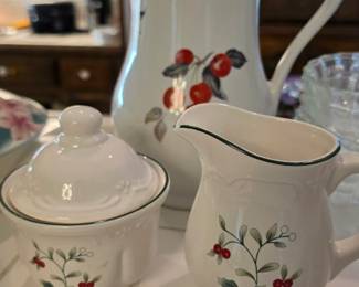 A Pfaltzgraff Winterberry pattern sugar bowl, creamer, and pitcher set.