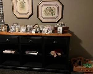 Kathy Ireland's Southampton black Console w/ contrasting natural wood top, Ethan Allen Botanical prints above