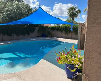 Blue shade sail over pool