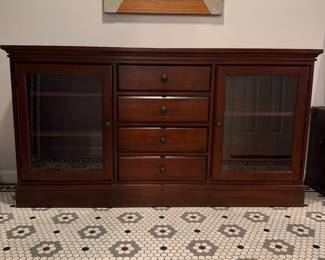 T32 - $175. Mahogany Finish Buffet. Measures 66.5" x 16.5" x 35" tall. Has 4 drawers that all slide easily and 2 glass doors with shelves inside.