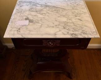 T61 - $150. Marble Top Table with Carved Lyre-Harp Pedestal. Measures 19" x 14" x 27.25" tall.