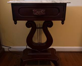 T61 - $150. Marble Top Table with Carved Lyre-Harp Pedestal. Measures 19" x 14" x 27.25" tall.