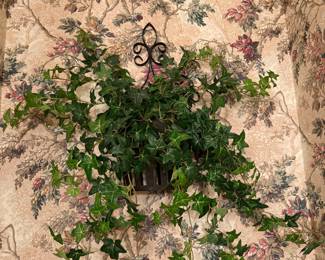 Wall-mounted metal planter with faux ivy vine arrangement