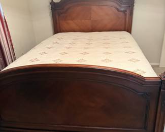 Carved wood queen bed frame with ornate crest headboard