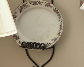 Floral rim porcelain plate on wrought iron wall hanger