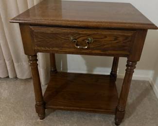 Oak side table with drawer, brass pull, and lower shelf