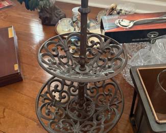 Two-tier scrolled metal serving stand with fleur-de-lis design