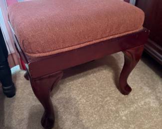 Queen Anne style footstool with cabriole legs and rust upholstered top