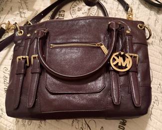 Michael Kors burgundy leather satchel with gold hardware and strap