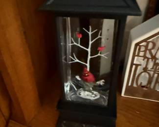 Black metal lantern with winter cardinal and tree scene