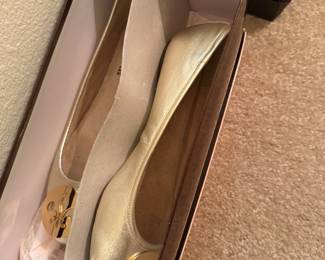 Gold leather ballet flats with fleur-de-lis medallion, in box
