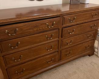 Oak 8-drawer dresser with brass drop pulls and mirror