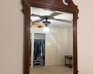 Chippendale style wood framed wall mirror with scrolled crest