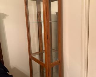 Oak curio cabinet with glass shelves and mirrored back