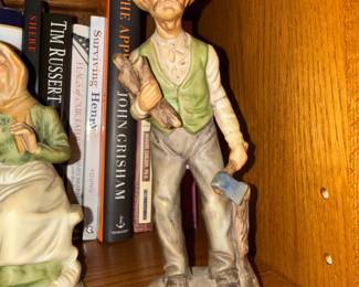 Porcelain figurine of old man farmer holding axe and wood